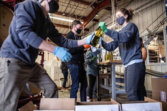 Employees bottle one of Odell's newest products: wine