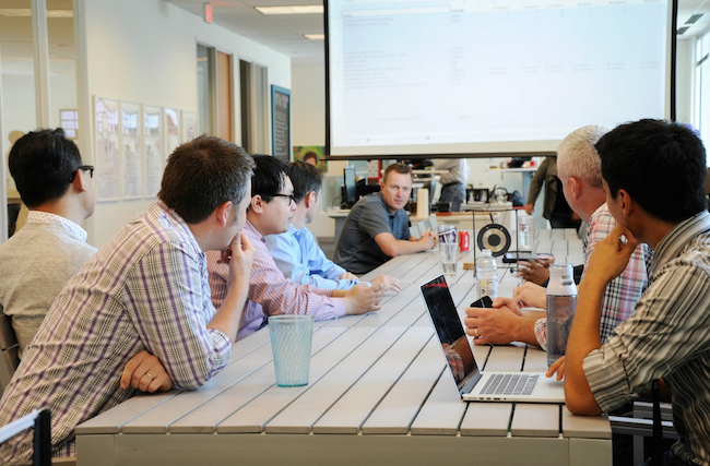 company_employees_meeting_at_table